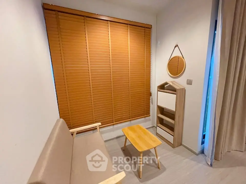 Cozy minimalist living room with wooden blinds and modern furniture