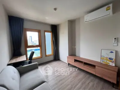 Modern living room with sleek furniture and city view, featuring air conditioning and stylish decor.