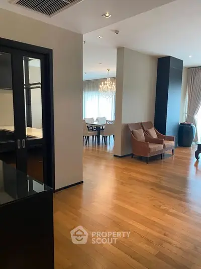 Spacious modern living room with elegant dining area and hardwood floors