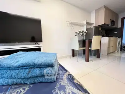 Modern open-plan living area with kitchen and dining space, featuring sleek furniture and contemporary design.