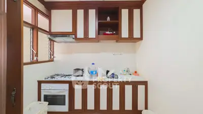 Charming kitchen with wooden cabinets and modern appliances, perfect for culinary enthusiasts.