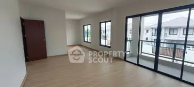 Spacious empty room with large windows and balcony access in modern home