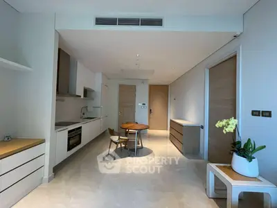 Modern open-plan kitchen and dining area with sleek design and natural light.