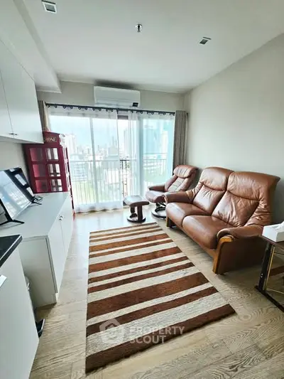Modern living room with leather sofas and city view balcony