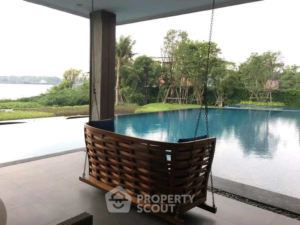 Luxurious poolside view with stylish wooden swing and lush greenery