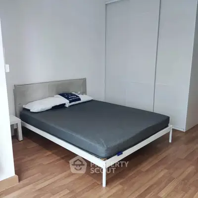 Modern bedroom with minimalist design and wooden flooring