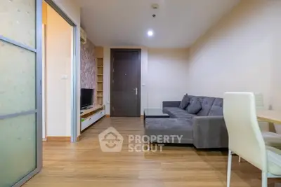 Modern living room with cozy gray sofa and wooden flooring