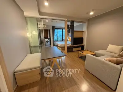 Modern open-plan living room with city view, featuring cozy seating and stylish decor.