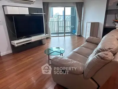 Spacious living room with modern furniture and balcony view in urban apartment.