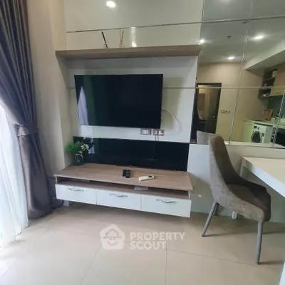 Modern living room with wall-mounted TV and stylish furniture