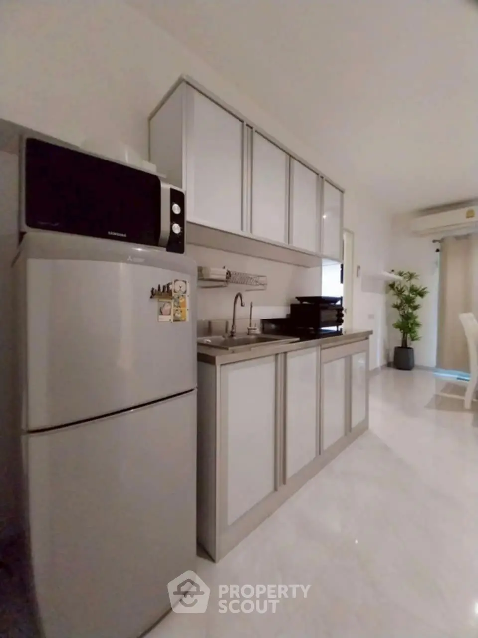 Modern kitchen with sleek cabinets and stainless steel appliances in a bright, airy space.