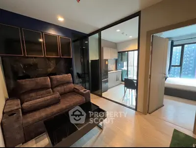 Modern apartment interior with open layout, featuring cozy living room and sleek kitchen design.