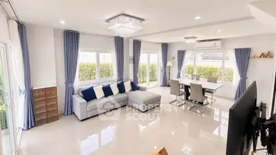 Spacious modern living room with elegant decor and large windows for natural light.