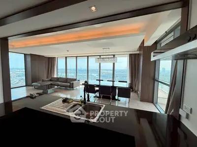 Luxurious open-plan living room with stunning city views and modern furnishings.
