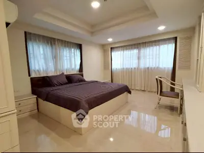 Spacious bedroom with elegant decor and natural light