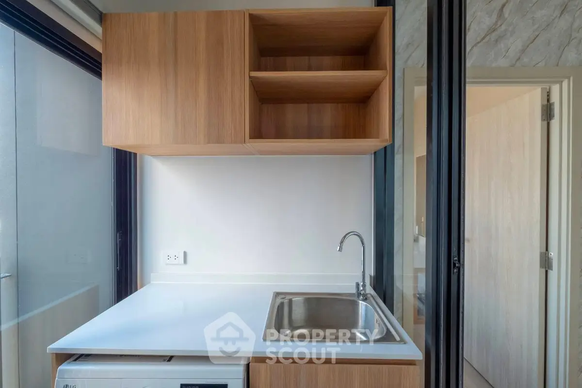 Modern kitchen with sleek wooden cabinets and stainless steel sink
