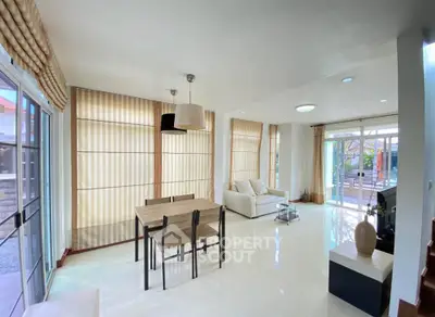 Spacious living room with modern decor and large windows for natural light.