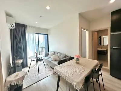 Modern living room with cozy sofa and dining area in bright apartment