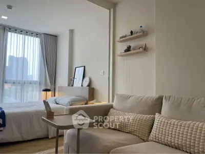 Modern studio apartment with cozy living area and natural light