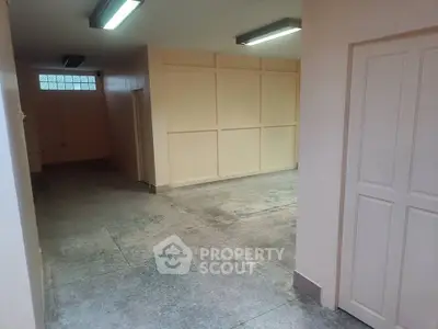 Spacious interior with potential for storage or conversion, featuring high ceilings and ample lighting.