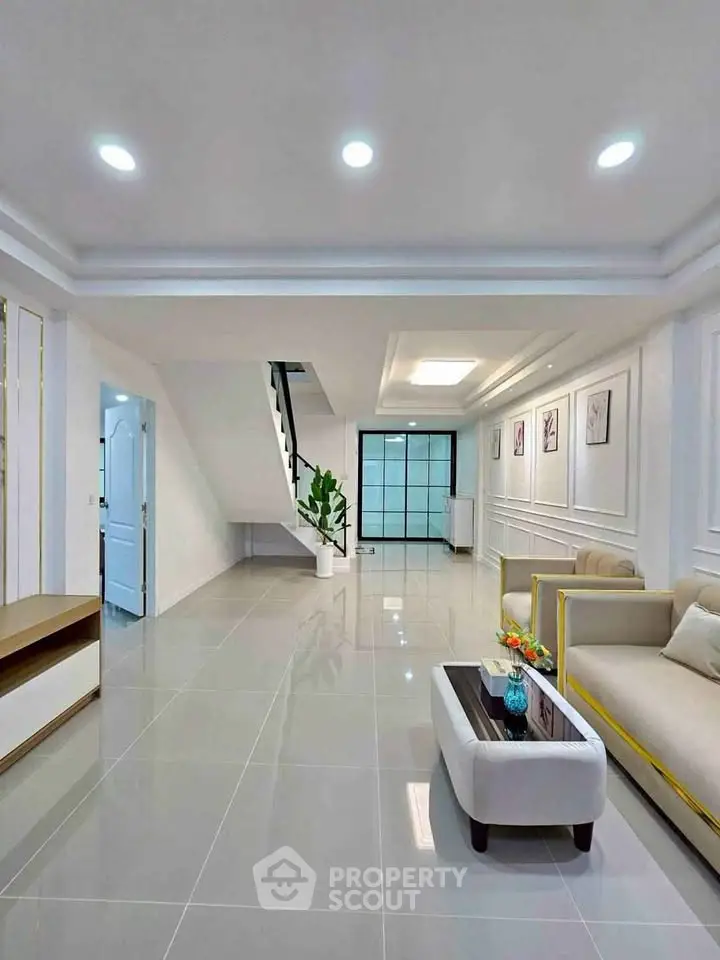 Spacious modern living room with elegant decor and ample natural light.