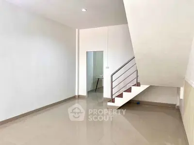 Spacious interior with modern staircase and glossy tiled flooring