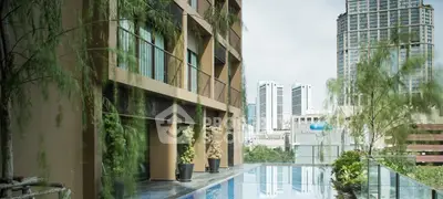 Luxurious urban apartment with stunning rooftop pool and city skyline view.