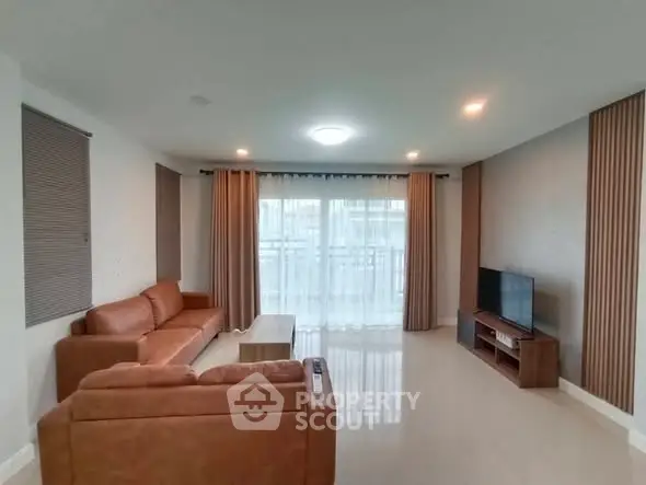 Spacious living room with modern furniture and large windows for natural light.