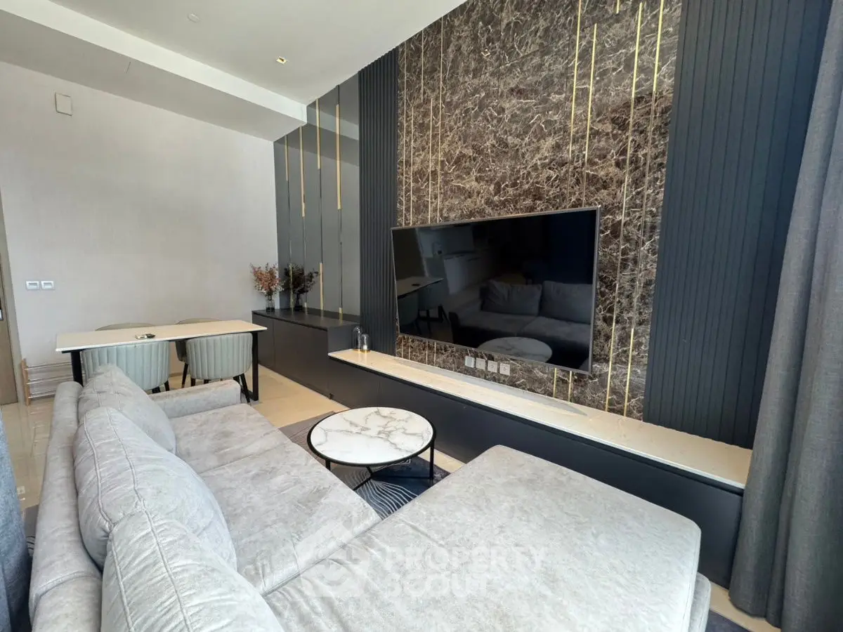Modern living room with elegant marble accent wall and sleek furniture