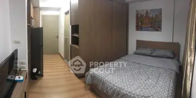 Cozy bedroom with modern decor and ample storage in a stylish apartment.