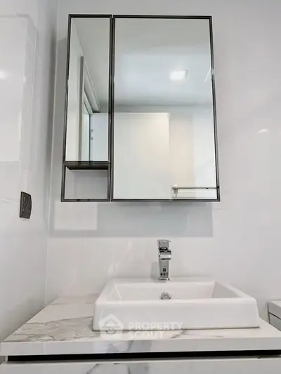 Modern bathroom with sleek mirror cabinet and stylish sink