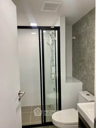 Modern bathroom with sleek shower enclosure and contemporary fixtures.