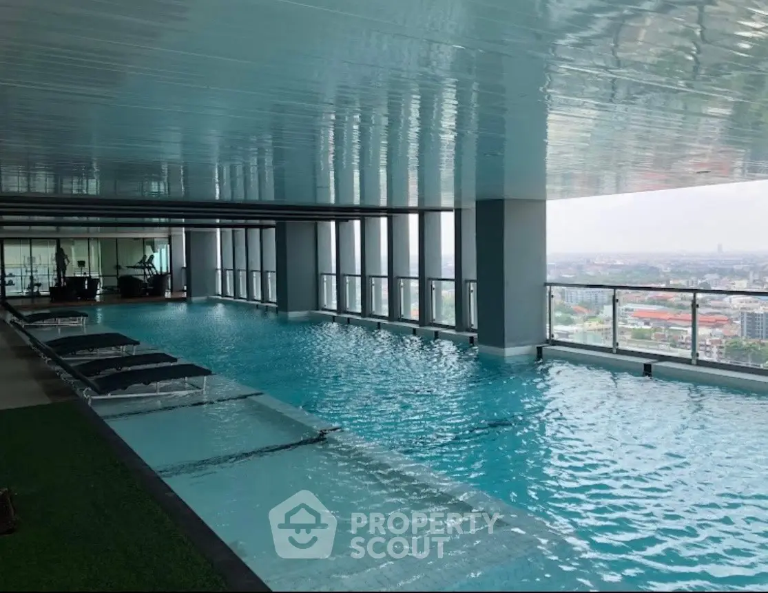 Luxurious rooftop infinity pool with stunning city views in a modern high-rise building.