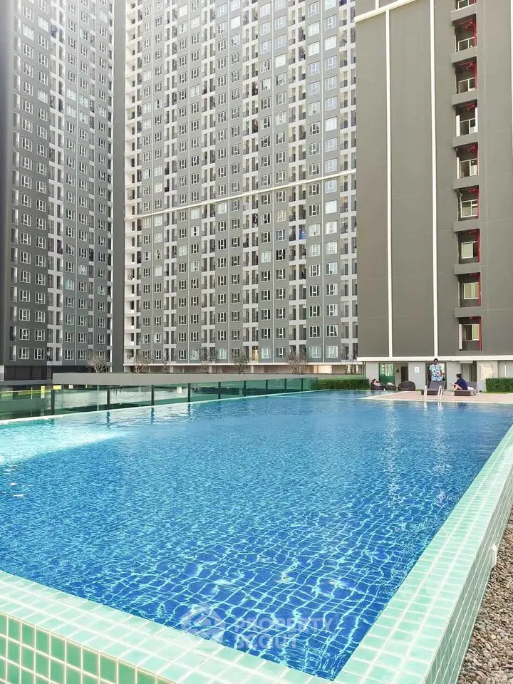 Luxurious high-rise apartment with stunning outdoor pool and modern architecture.