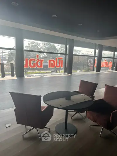 Spacious modern interior with large windows and stylish seating area