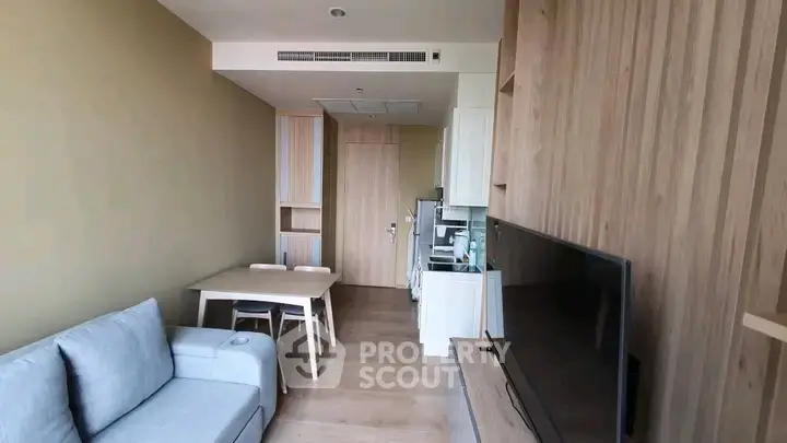 Modern living room with wooden accents and cozy furniture in a stylish apartment.