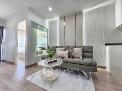 Modern living room with stylish decor and cozy ambiance in a contemporary apartment.