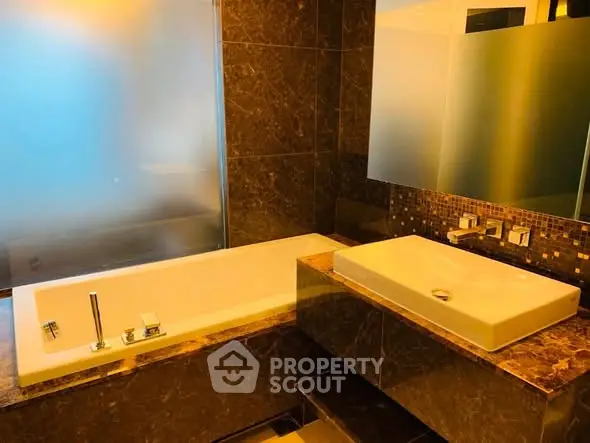 Luxurious bathroom with elegant marble finishes and modern fixtures.