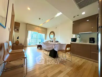 Spacious modern living room with open kitchen and balcony view in a stylish apartment.