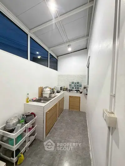 Modern kitchen with sleek design and ample storage space, featuring a minimalist aesthetic and efficient layout.