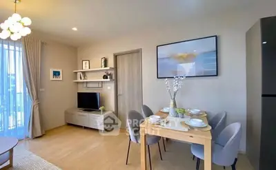 Modern living room with dining area, stylish decor, and natural light.