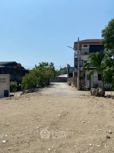 Charming rural property with spacious outdoor area and multi-story building.