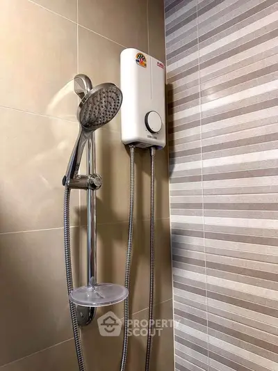 Modern bathroom with sleek showerhead and water heater, featuring stylish tile design.