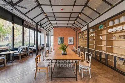 Spacious modern dining area with large windows and stylish decor, perfect for gatherings and entertaining.
