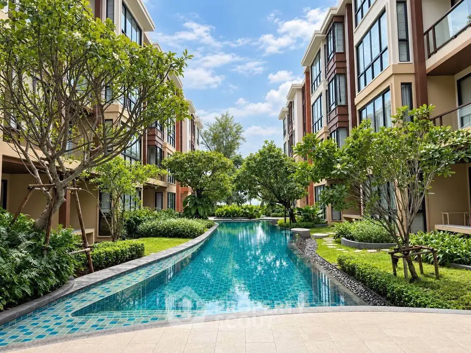 Luxurious residential complex with stunning pool and lush gardens, perfect for serene living.