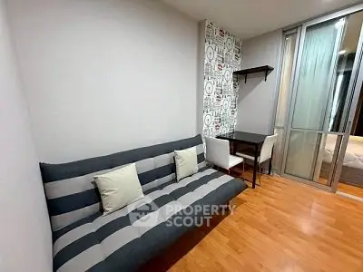 Modern studio apartment with stylish decor and cozy seating area.