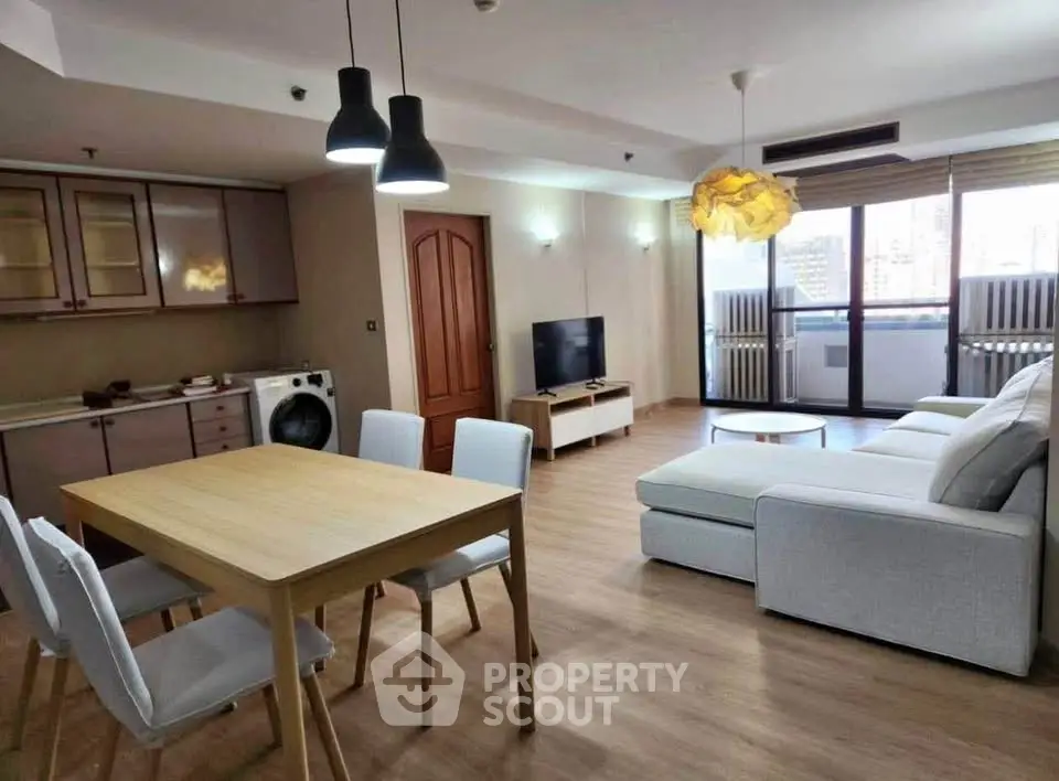 Spacious modern living room with open kitchen and stylish decor in a bright apartment.