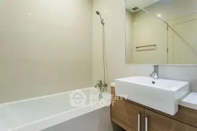 Modern bathroom with sleek fixtures and a spacious bathtub in a contemporary home.