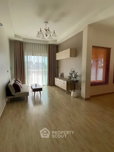 Spacious living room with modern decor and large windows for natural light.