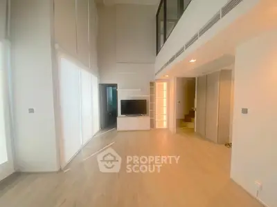 Spacious modern living room with high ceilings and natural light